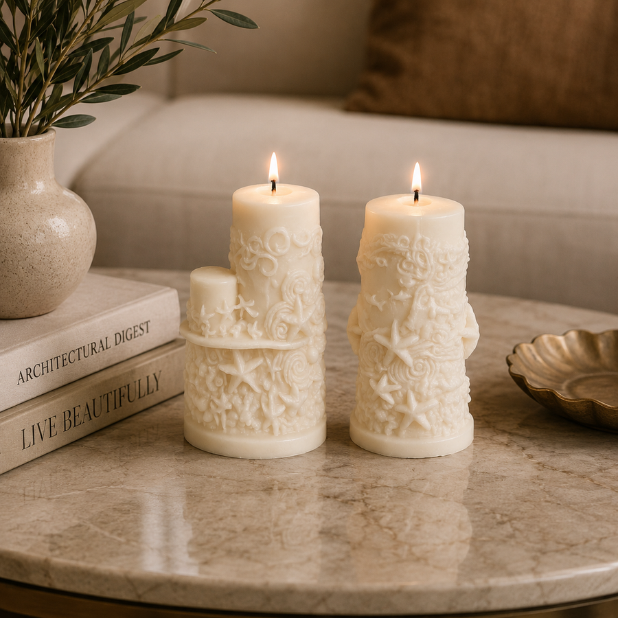Three cream-colored wax candles with embossed floral and starfish patterns, arranged on a marble table next to a stack of books and a vase in a cozy living room setting.
طقم شموع ديكور كريمي من قطعتين بتفاصيل بحرية بارزة مستوحاة من الأصداف والنجوم لتزيين المنزل والكونسول.